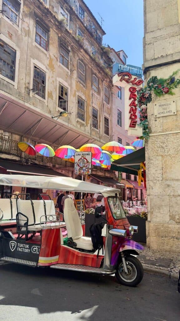 A TukTuk parked in front of the famous pink street in Lisbon, heart of the nightlife
