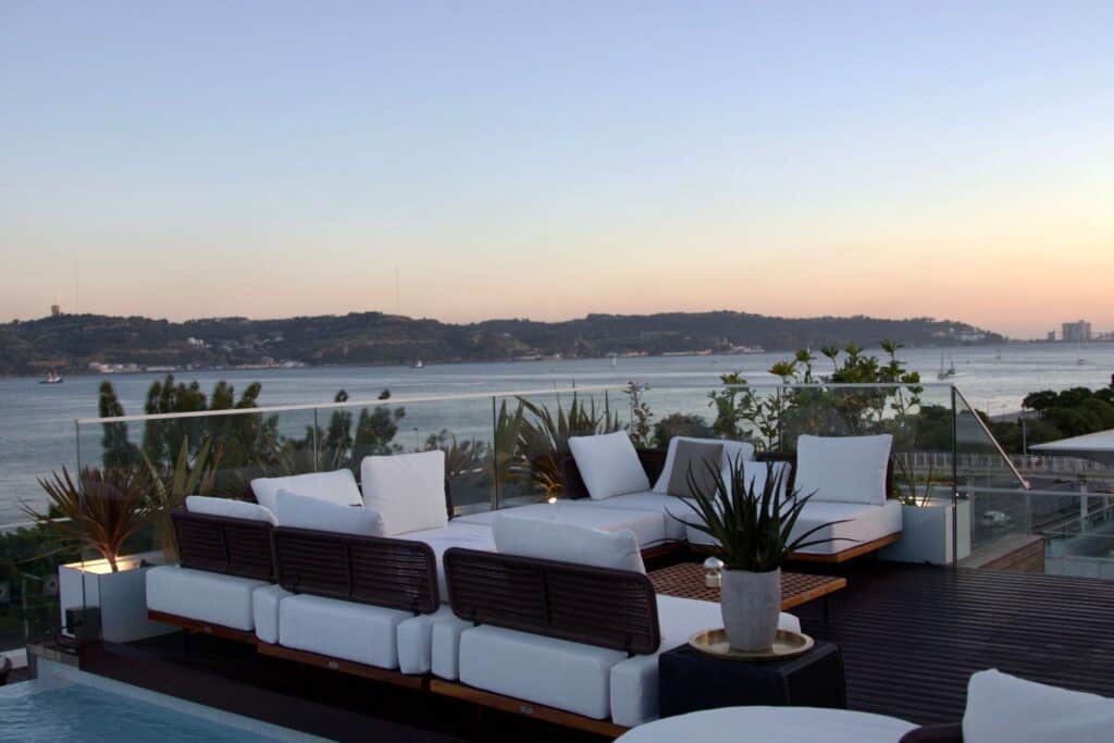 Tagus view from a rooftop bar having white sofas and dark wooden floor