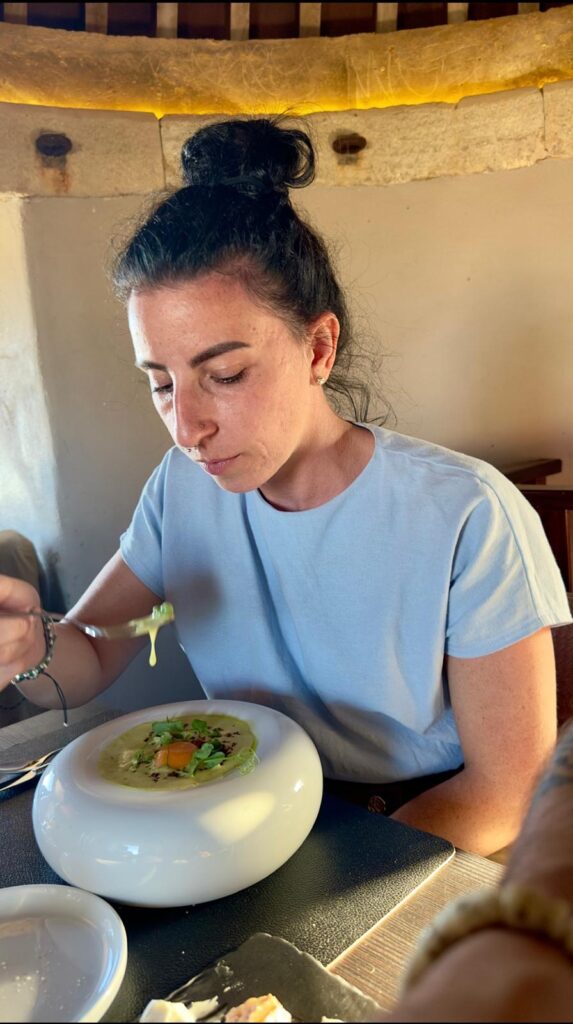 Myself tasting an impeccably presented starter served in a unique, white spherical bowl inside the intimate dining room of the Windmill restaurant.