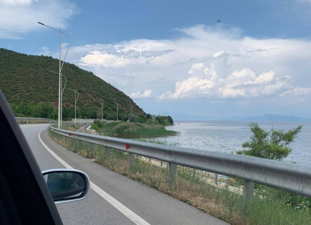 Driving beside Lake Pogradec on a scenic road in Albania