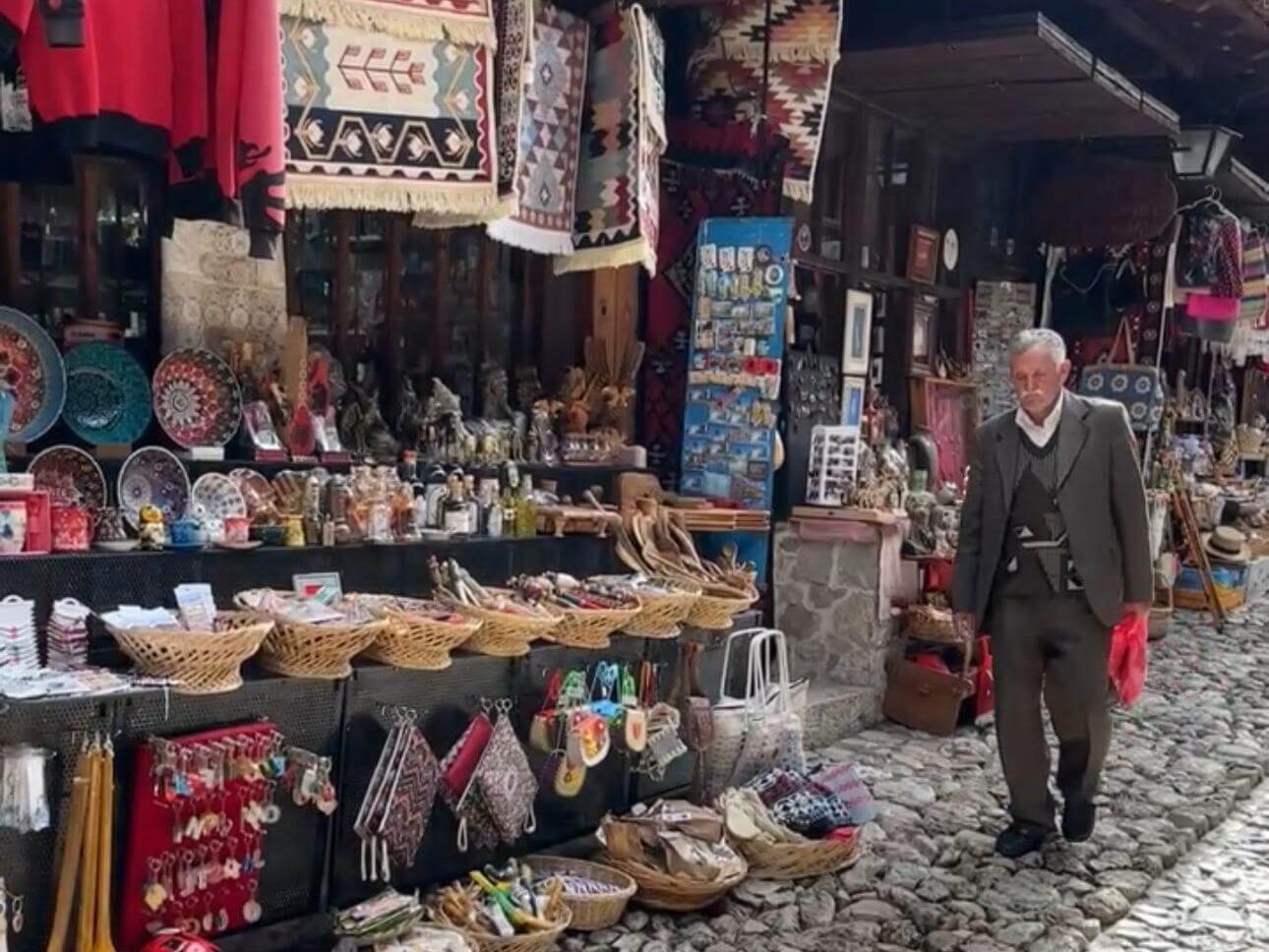 Souvenir shops on the cobbled street outside Krujë Castle in Albania selling textiles, pottery and local crafts